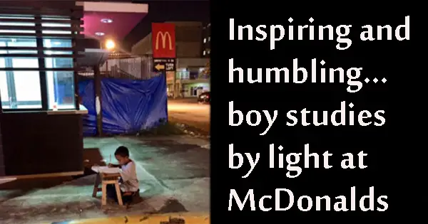 Inspiring nine-year-old does homework in light from McDonalds