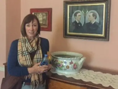 Robin Pearse Stetler stands by photo of her relatives Patrick and Willie Pearse