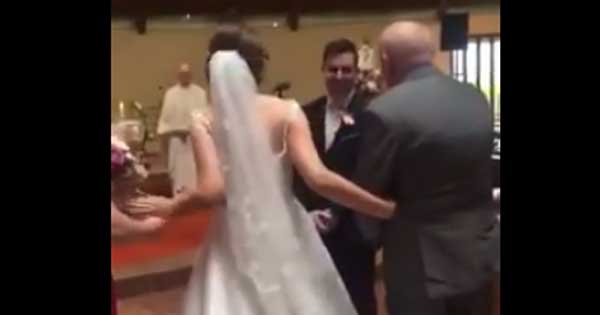 Groom sings to his bride as she walks down the aisle
