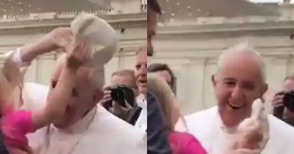 A cheeky youngster gave the Pope a good laugh as she steals his skullcap