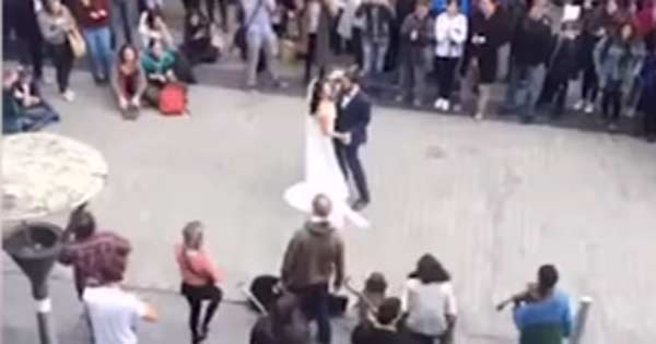 Irish newlyweds dance to a band of buskers on Shop Street, Galway