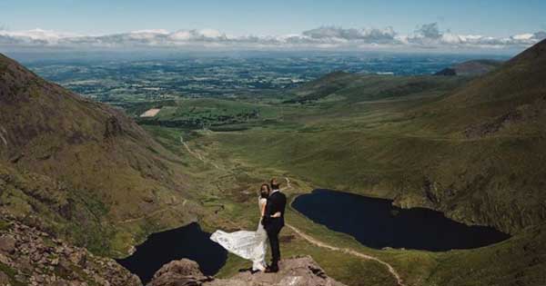 Couple hike up mountain to get this stunning wedding picture