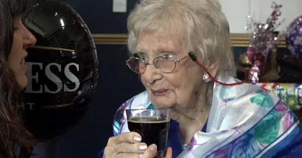 Old lady drinking Guinness