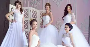 five women in wedding dresses