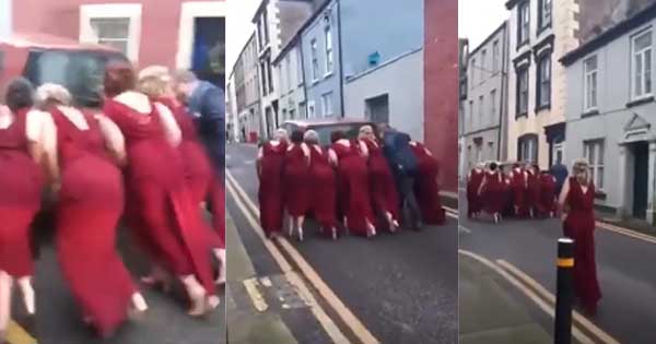 Bridesmaids push broken down car out of the way so the bride can get to church on time