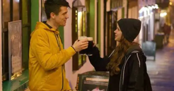 Couple drink a Guinness on an Irish street