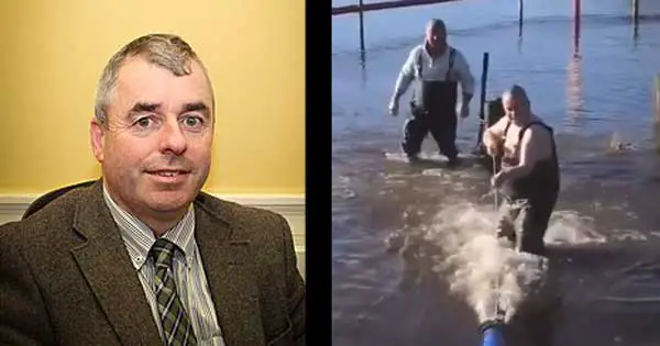 Irish politician splits opinion by  wading into water to help prevent flooding