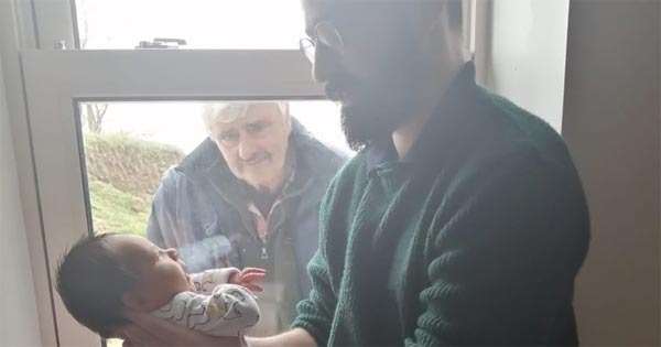 Irish granddad sees his grandson for the first time through a window