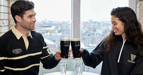 Man and woman with pints of Guinness