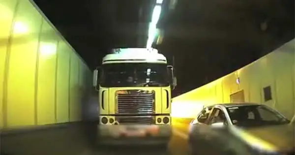 truck driver won't let queue jumper merge in tunnel footage from dashcam